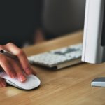 In August 2018, a person adeptly navigates their tasks using a computer mouse and keyboard at a desk in the Winners' Resource Center, seamlessly merging productivity with technology.