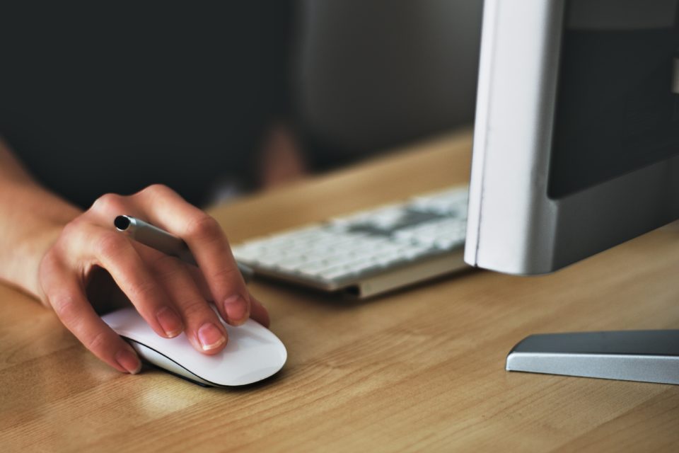 In August 2018, a person adeptly navigates their tasks using a computer mouse and keyboard at a desk in the Winners' Resource Center, seamlessly merging productivity with technology.